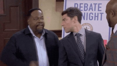 Three Men Standing In Front Of Debate Sign GIF