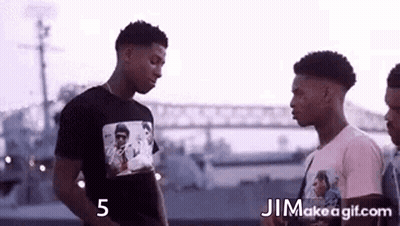 Three Men Standing Near Bridge GIF