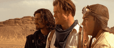 Three Men Standing Next To Each Other In The Desert GIF