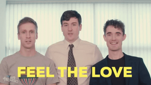 Three Men Standing Next To Each Other With The Words " Feel The Love " Written In Yellow GIF