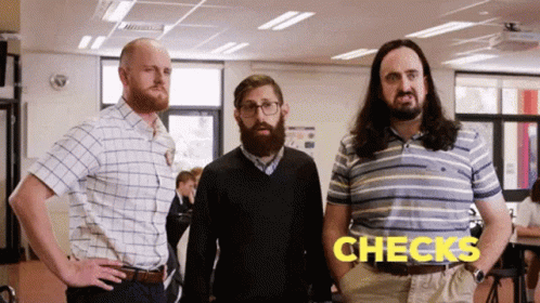 Three Men Standing Next To Each Other With Word Checks On Screen GIF