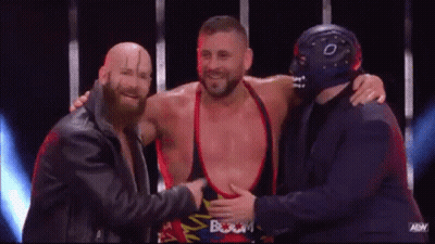 Three Men Standing On Stage One Wearing Mask GIF