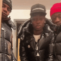 Three Men Wearing Black Jackets And Red Hats Are Posing For A Picture Together GIF
