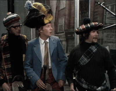 Three Men Wearing Kilts Are Standing In Front Of A Building That Says Original GIF