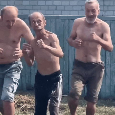 Three Men Without Shirts Are Running In Front Of A Fence GIF