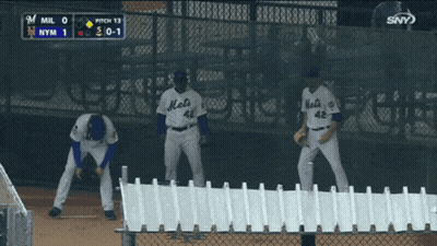Three Mets Baseball Players Are Standing On The Field During A Game GIF