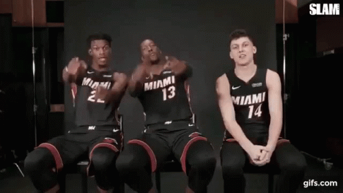 Three Miami Heat Basketball Players Are Sitting Next To Each Other In Chairs . GIF