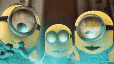 Three Minions Wearing Goggles Looking At Camera GIF