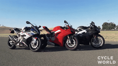Three Motorcycles Are Parked Next To Each Other With Cycle World Written On The Bottom Right GIF