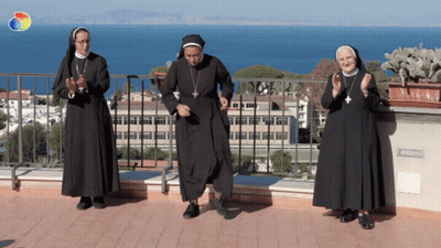 Three Nuns Dancing On Balcony Overlooking Ocean GIF