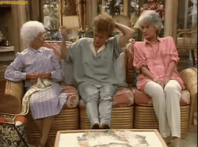 Three Older Women Are Sitting On A Couch In A Living Room . One Of The Women Is Wearing A Pink Shirt . GIF