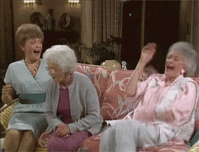 Three Older Women Are Sitting On A Couch Laughing And Having Fun . GIF