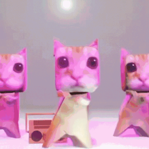 Three Origami Cats Are Standing Next To Each Other GIF