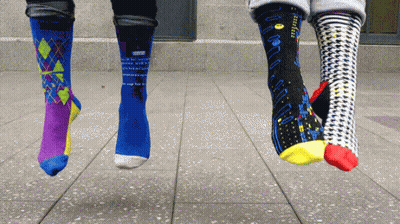 Three Pairs Of Socks Hanging From Feet With Pac-Man GIF
