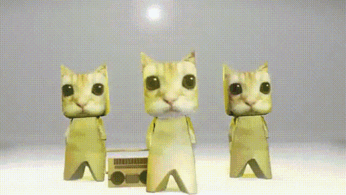 Three Paper Cats Are Dancing In Front Of A Boombox On A Table GIF