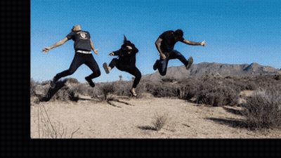 Three People Are Jumping In The Air With One Wearing A T-Shirt That Says ' Freedom ' GIF