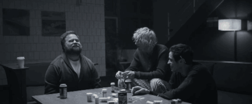Three People Are Sitting At A Table With Bottles Of Pills GIF