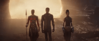 Three People Are Standing Next To Each Other In A Cave . GIF