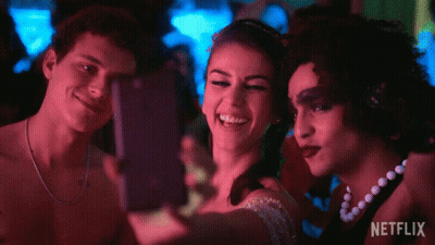 Three People Are Taking A Selfie With A Netflix Logo In The Background GIF