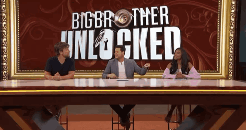 Three People At Table In Front Of Big Brother Unlocked Poster GIF