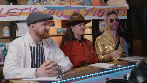 Three People At Table With Lets Do A Fight Sign GIF