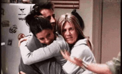 Three People Hugging In Kitchen GIF