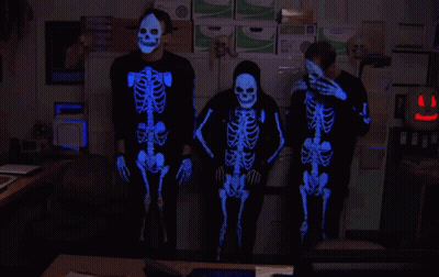 Three People In Glow In The Dark Skeleton Costumes GIF