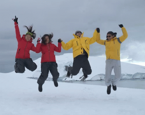 Three People Jumping In The Air With Their Arms In The Air GIF