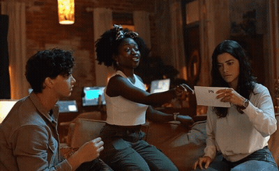 Three People On Couch Holding FPS Paper GIF