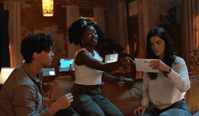 Three People On Couch One Holding Paper Saying PS GIF