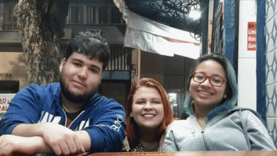 Three People Posing For A Picture With One Wearing A Blue Sweatshirt That Says Iowa GIF