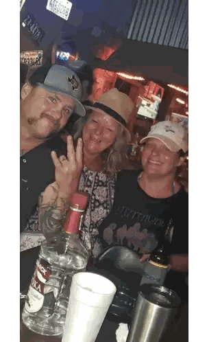 Three People Posing With Vodka Sticker