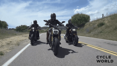 Three People Riding Motorcycles On A Road With The Words Cycle World On The Bottom Right GIF