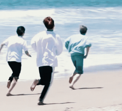 Three People Running On A Beach GIF