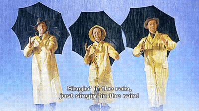 Three People Singin' In The Rain With Umbrellas GIF