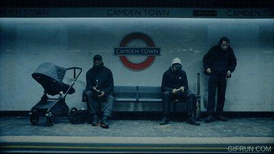 Three People Sit On A Bench At Camden Town Subway Station GIF
