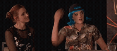 Three People Sitting At Table With Hands On Head GIF