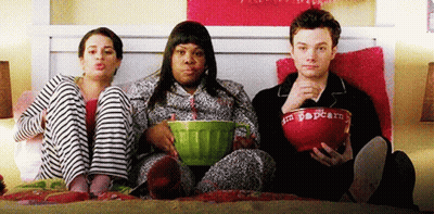 Three People Sitting On Bed With Popcorn GIF