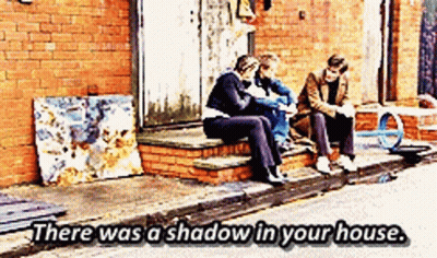 Three People Sitting On Brick Steps Saying There Was A Shadow In Your House GIF