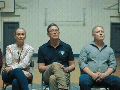 Three People Sitting With SDS Shirt GIF