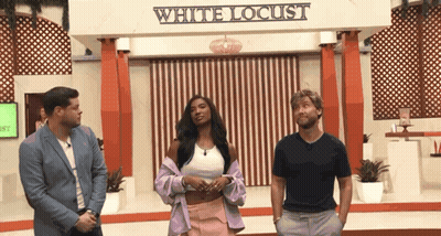Three People Standing In Front Of White Locust Sign GIF