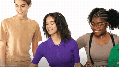Three People Standing With One in Purple Top