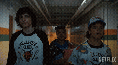 Three People Walking Down Hallway Hellfire Club Shirt GIF
