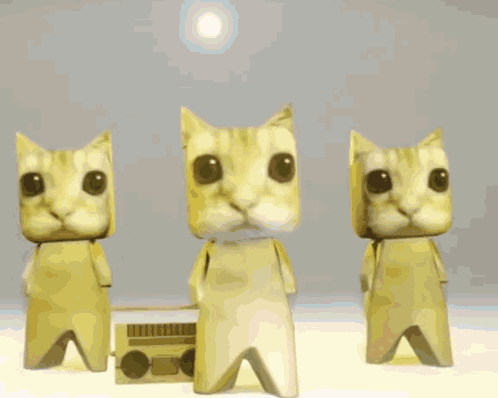 Three Pink Origami Cats Are Dancing In Front Of A Radio GIF