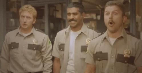 Three Police Officers Are Standing Next To Each Other And Holding Guns . GIF