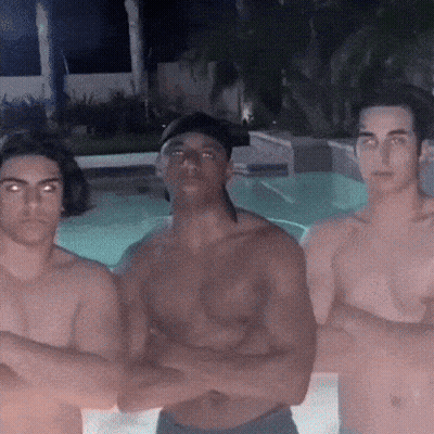 Three Shirtless Men Are Posing For A Picture In Front Of A Pool GIF