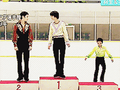 Three Skaters Are Standing On A Podium With Numbers 1 2 And 3 On Them GIF