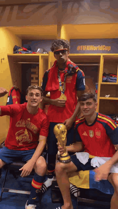 Three Soccer Players Are Posing For A Picture In A Locker Room With A Sign That Says #Fifaworldcup GIF