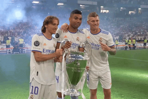 Three Soccer Players Holding A Trophy With Emirates Better Written On Their Shirts GIF