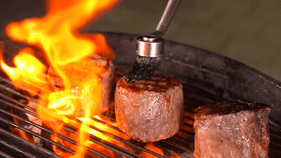 Three Steaks On Grill With Brush GIF